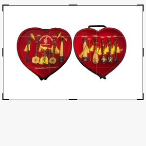 Vietnamese musical mini wooden instruments in a heart shape shadow box.